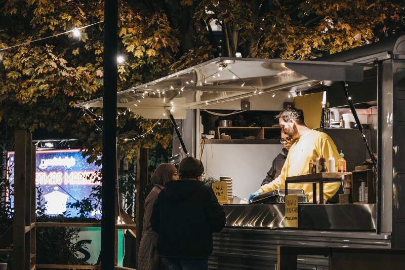 A photo of the food truck open at night.