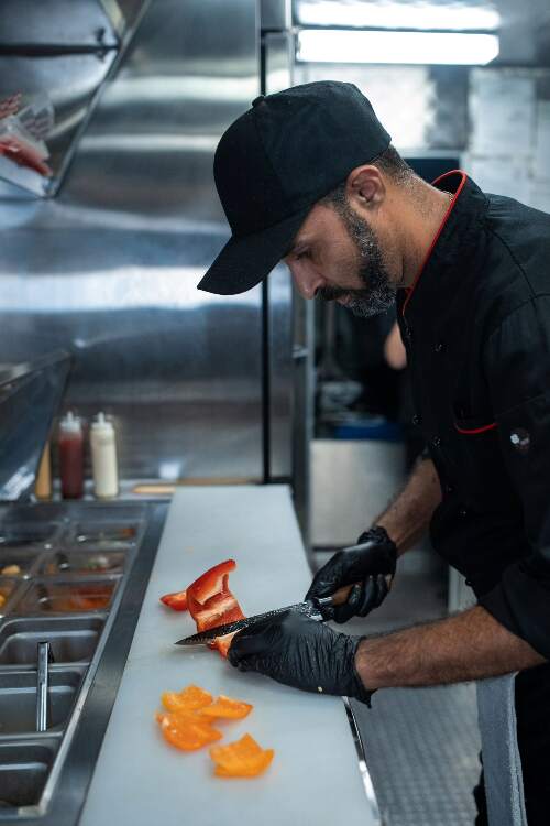 Photo of a chef chopping a pepper