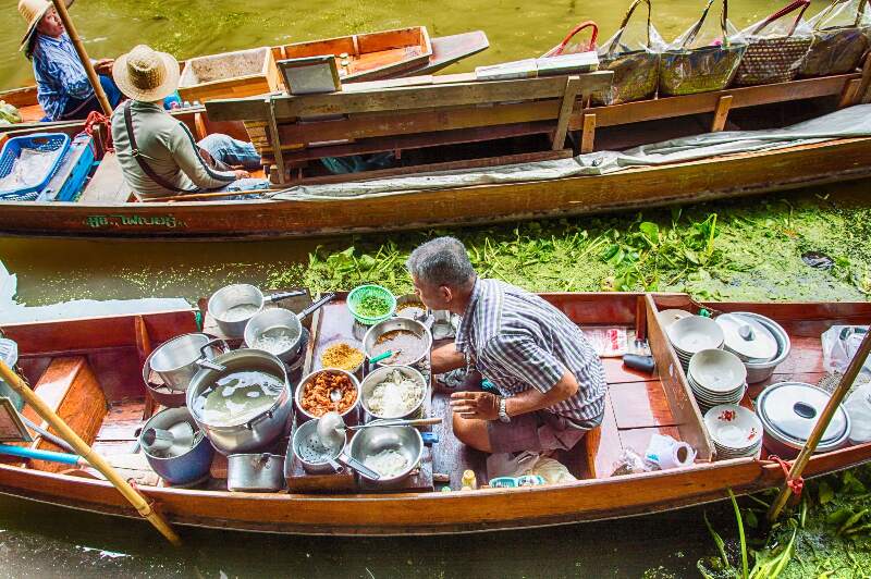 A photo of one of the boats on the floating market in Thailand.